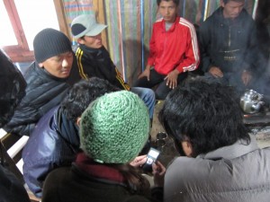 Allie showing videos in Nepali tea house
