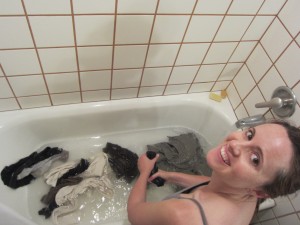 woman washing clothes in bath tub